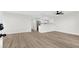 Open-concept living area with wood floors, white walls, and a modern ceiling fan at 2480 Old Forge Ln # 74, Las Vegas, NV 89121