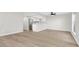 Open-concept living area with wood floors, white walls, and a modern ceiling fan at 2480 Old Forge Ln # 74, Las Vegas, NV 89121