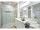 Bright bathroom with double sinks, quartz countertop, modern fixtures, and a glass-enclosed shower at 2561 Terrytown Ave, Henderson, NV 89052
