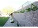 Landscaped backyard with a decorative retaining wall and lush plants at 2623 Red Planet St, Henderson, NV 89044