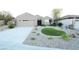 Beautiful one-story home featuring a well-manicured front yard with gravel landscaping, artificial turf, and desert plants at 2623 Red Planet St, Henderson, NV 89044
