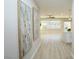 Bright and spacious hallway featuring light wood floors, recessed lighting, and two decorative art pieces at 2623 Red Planet St, Henderson, NV 89044