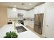 Bright kitchen with white cabinets, quartz countertops, stainless steel appliances, and a kitchen island at 2623 Red Planet St, Henderson, NV 89044