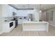 Contemporary kitchen featuring white cabinetry, stainless steel appliances, quartz countertops, and an island at 2623 Red Planet St, Henderson, NV 89044