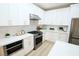 Bright kitchen features white cabinets, stainless steel appliances, and light countertops and backsplash at 2623 Red Planet St, Henderson, NV 89044