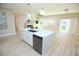 Modern kitchen with a central island, stainless steel appliances, and an open view to the living area and backyard at 2623 Red Planet St, Henderson, NV 89044