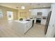 Open-concept kitchen featuring a large island, stainless steel appliances, and sliding doors to the backyard at 2623 Red Planet St, Henderson, NV 89044
