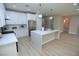 Bright kitchen featuring white cabinets, stainless steel appliances, quartz countertops, and a large island at 2623 Red Planet St, Henderson, NV 89044