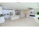 Open concept living area boasts light, wood-look floors, a fireplace and seamless access to the kitchen at 2623 Red Planet St, Henderson, NV 89044