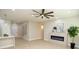 Light filled living room with a fireplace, an elegant ceiling fan and direct access to the kitchen area at 2623 Red Planet St, Henderson, NV 89044