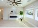 This living room offers plenty of natural light from its expansive windows, highlighting a modern fireplace at 2623 Red Planet St, Henderson, NV 89044