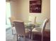 Elegant dining room with a glass-top table and stylish upholstered chairs at 2629 Mocha Pearl Ct, North Las Vegas, NV 89086