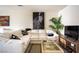 Cozy living room showcasing a comfortable sectional sofa, modern art, and a stylish coffee table, great for relaxing at 2629 Mocha Pearl Ct, North Las Vegas, NV 89086