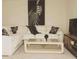 Bright living room with a comfortable white sectional and modern decor at 2629 Mocha Pearl Ct, North Las Vegas, NV 89086