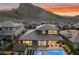 A panoramic aerial view of a home with a backyard pool and mountain views at 2680 Nevada Agave Ln, Las Vegas, NV 89138