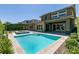 A backyard with a swimming pool, hot tub, pergola, and patio with lounge chairs at 2680 Nevada Agave Ln, Las Vegas, NV 89138