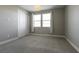A bedroom with neutral walls and carpet and a double window for natural light at 2680 Nevada Agave Ln, Las Vegas, NV 89138