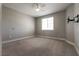 A clean, empty bedroom with neutral walls and carpet, TV hookup and a ceiling fan at 2680 Nevada Agave Ln, Las Vegas, NV 89138