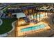 Stunning community pool area with palm trees, lounge chairs, and modern architecture at 2680 Nevada Agave Ln, Las Vegas, NV 89138