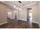 Elegant dining area with hardwood floors and a modern chandelier, leading to the kitchen at 2680 Nevada Agave Ln, Las Vegas, NV 89138