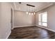 Modern dining area featuring hardwood floors, stylish lighting, and a large window at 2680 Nevada Agave Ln, Las Vegas, NV 89138