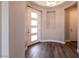 Bright foyer with a modern light fixture, hardwood flooring, and a contemporary door at 2680 Nevada Agave Ln, Las Vegas, NV 89138