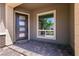 Stylish front entryway with a modern door and brick-paved porch at 2680 Nevada Agave Ln, Las Vegas, NV 89138