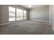 Bright room with many windows and backyard view with neutral walls and flooring at 2680 Nevada Agave Ln, Las Vegas, NV 89138