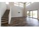 Spacious living room with high ceilings, modern staircase, and sliding glass doors at 2680 Nevada Agave Ln, Las Vegas, NV 89138