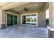 Covered patio featuring a ceiling fan and large sliding doors leading to an outdoor pool at 2680 Nevada Agave Ln, Las Vegas, NV 89138