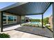 Modern louvered pergola providing shade to a stylish patio with artificial turf accents at 2680 Nevada Agave Ln, Las Vegas, NV 89138