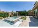 Backyard pool with attached spa, pergola, lounge chairs, and pristine patio at 2680 Nevada Agave Ln, Las Vegas, NV 89138