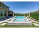 A modern pool with a spa and clean tile accents nestled in a private backyard oasis at 2680 Nevada Agave Ln, Las Vegas, NV 89138