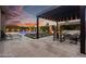 Evening view of a backyard pool, spa, and pergola-covered outdoor seating area at 2680 Nevada Agave Ln, Las Vegas, NV 89138