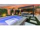 Backyard view showcasing in-ground spa and an outdoor dining area at 2680 Nevada Agave Ln, Las Vegas, NV 89138