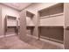 Spacious walk-in closet with empty shelving units and neutral walls and flooring at 2680 Nevada Agave Ln, Las Vegas, NV 89138
