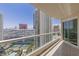 Condo balcony with a view of the city, surrounding buildings, pool, and tennis courts at 2777 Paradise Rd # 2302, Las Vegas, NV 89109