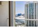 View of the city and neighboring buildings from the condo balcony through sliding glass doors at 2777 Paradise Rd # 2302, Las Vegas, NV 89109