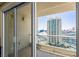 View of the city and neighboring buildings from the condo balcony through sliding glass doors at 2777 Paradise Rd # 2302, Las Vegas, NV 89109