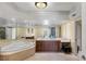 Bathroom features a large jacuzzi tub, modern vanity, and a large mirror at 2777 Paradise Rd # 2302, Las Vegas, NV 89109