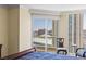 Bedroom with a large window providing city views, accent chair, and hardwood floors at 2777 Paradise Rd # 2302, Las Vegas, NV 89109