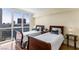 Bedroom featuring hardwood floors, two twin beds, and a large window with a city view at 2777 Paradise Rd # 2302, Las Vegas, NV 89109