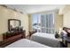 Bedroom featuring twin beds, city views, dresser, and hardwood floors at 2777 Paradise Rd # 2302, Las Vegas, NV 89109
