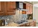 Close-up of kitchen showcases stainless steel gas range, granite counters, and custom wood cabinets at 2777 Paradise Rd # 2302, Las Vegas, NV 89109