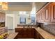 Bright open kitchen with granite counters, stainless steel appliances, and wood cabinets with city views at 2777 Paradise Rd # 2302, Las Vegas, NV 89109
