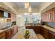 Open kitchen offers granite counters, stainless steel appliances, wooden cabinets and island at 2777 Paradise Rd # 2302, Las Vegas, NV 89109