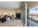 Modern living room featuring a fireplace and a sliding glass door that opens to a balcony with city views at 2777 Paradise Rd # 2302, Las Vegas, NV 89109