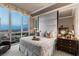 Elegant bedroom with floor-to-ceiling windows offering city and mountain views, a comfortable seating area, and upscale decor at 2877 Paradise Rd # 2602, Las Vegas, NV 89109