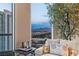 Relaxing view of city and mountains from a bedroom lounge area, with a tree inside, creating a calming atmosphere at 2877 Paradise Rd # 2602, Las Vegas, NV 89109