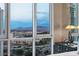 Bedroom boasts city and mountain views through expansive windows, with a dark dresser complementing the serene setting at 2877 Paradise Rd # 2602, Las Vegas, NV 89109